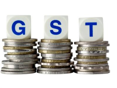 GST letters on coins