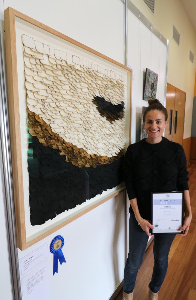 Caption – The 2023 Overall Acquisitive Prize winner Tatiana Amaral with her piece The  Dark Gold
