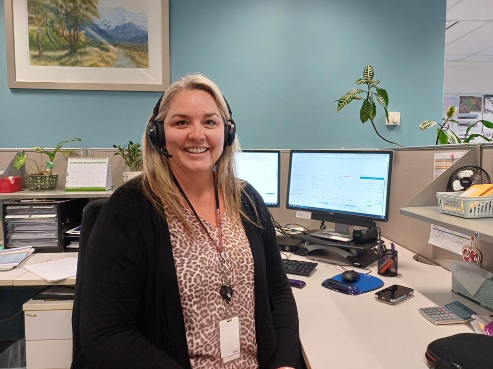 Mel, Bookings officer at her desk