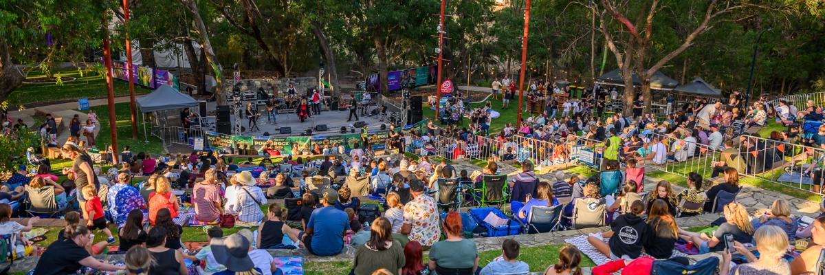 Image of large crowd looking down at a stage