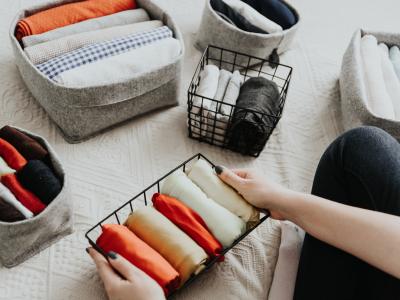 A variety of folded clothes neatly organised into containers